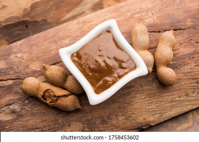 Tamarind Or Imli Fresh Puree, Paste From Pulp, Served In A Bowl With Whole Fruit