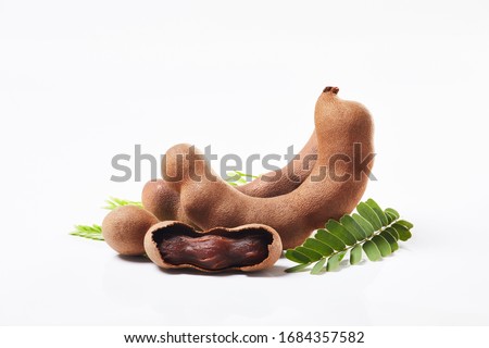 tamarind open with leaves on white background