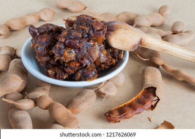 Tamarind Pulp Taken On A White Plate Surrounded By Tamarind Pods