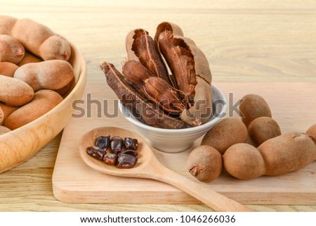 Tamarind set for health & Beauty treatment spa, hair, skin scrub, diet fruit & snack, Tamarind ripe peel shell, seeds in wood spoon in chopboard place on wooden background, selective focus, copy space Stock photo © 