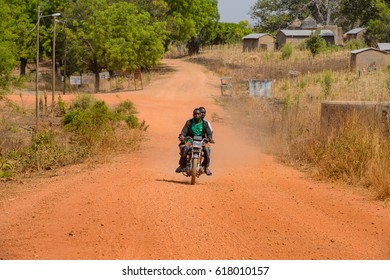 TAMBERMA VIL, TOGO - JAN 13, 2017: Unidentified Tammari Men Go By Motorcycle On The Road In The Village. Tammaris Are Ethnic Group Of Togo And Benin