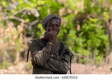 TAMBERMA VIL, TOGO - JAN 13, 2017: Unidentified Tammari The Guy In The Hat And Jacket Holds His Hand Near The Face In The Village. Tammaris Are Ethnic Group Of Togo And Benin