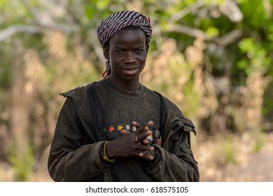 TAMBERMA VIL, TOGO - JAN 13, 2017: Unidentified Tammari  The Guy In The Hat And In The Jacket Folds His Hands In Front Of Him In The Village. Tammaris Are Ethnic Group Of Togo And Benin