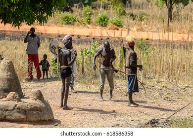 TAMBERMA VIL, TOGO - JAN 13, 2017: Unidentified Tammari Men With National Attributes And People In Colored Clothes In The Village. Tammaris Are Ethnic Group Of Togo And Benin