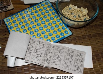 Tambola Bingo Housie Tickets, Coin And Board On Table. Popular Diwali And Kitty Party Game.