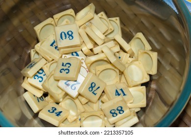 Tambola Number Coin In A Glass Bowl On Table. Popular Diwali And Kitty Party Game.