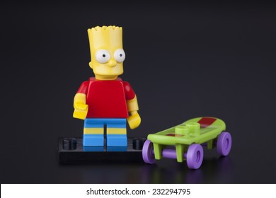 Tambov, Russian Federation - April 30, 2014 Lego Bart Simpson Minifigure With Skateboard On Black Background. Studio Shot.