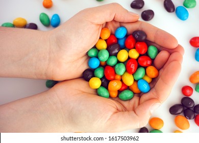 Tambov, Russian Federation - December 05, 2019 M&Ms Candy In Woman Hands. White Background.