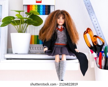 Tambov, Russian Federation - February 15, 2022 A Mattel Harry Potter Hermione Granger Doll Sitting On A Shelf Near A Plant And Some Pens