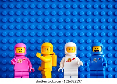 Tambov, Russian Federation - February 24, 2019 Four Lego astronaut minifigures against blue baseplate background. The LEGO Movie 2. 