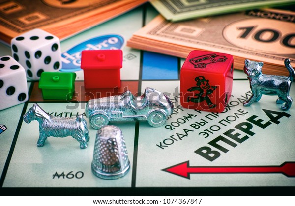Tambov, Russian Federation - January 26, 2018\
Monopoly Board Game. Field Go of gameboard with tokens, dices,\
money and houses. Studio\
shot.