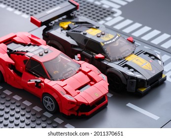 Tambov, Russian Federation - July 07, 2021 Lego Ferrari F8 Tributo and Lego Chevrolet Corvette C8.R race cars on road baseplate. Lego Speed Champions.