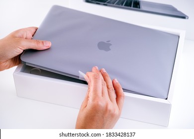 Tambov, Russian Federation - July 09, 2020 Woman Hands Unboxing New MacBook Pro. 