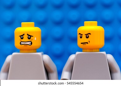 Tambov, Russian Federation - July 24, 2016 Two Lego minifigures - one mad and one scared. Blue background. Studio shot.