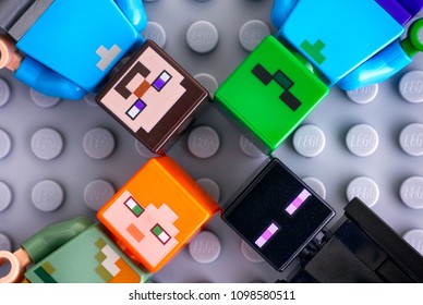 Tambov, Russian Federation - May 20, 2018 Four Lego Minecraft minifigures - Steve, Alex, enderman, zombie, on gray background. Studio shot.