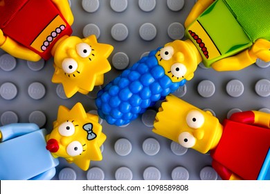 Tambov, Russian Federation - May 20, 2018 Four Lego Simpsons minifigures - Marge, Bart, Lisa, and Maggie, on gray background. Studio shot.