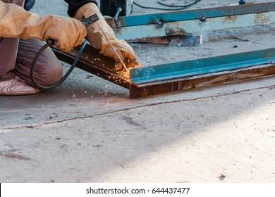 tame welder. the welder welds iron. the welder welds metal. the welder on metal.