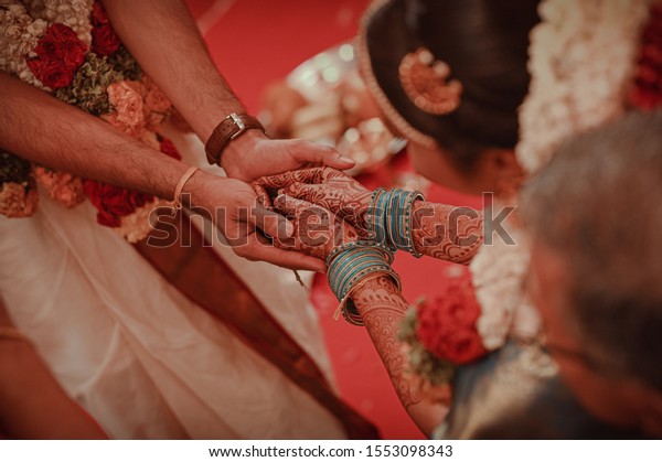 Tamil Brahmin\
Couple holding hands after\
wedding