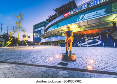 Tampa, FL—Sept 13, 2021; statue of Phil Esposito stands in front of Amalie Arena home to Tampa Bay Lightning NHL franchise at sunrise