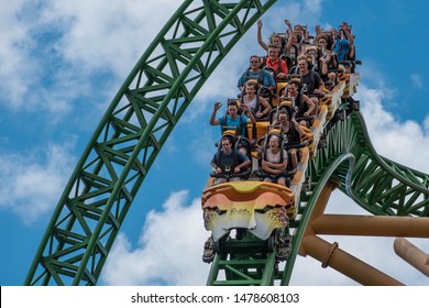 Tampa Bay, Florida. August 08, 2019. People amazing terrific Cheetah Hunt rollercoaster on lightblue cloudy sky background 79
