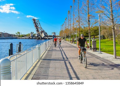 Tampa Bay, Florida. March 02, 2019 People Biking At Riverwalk In Downtown Area .