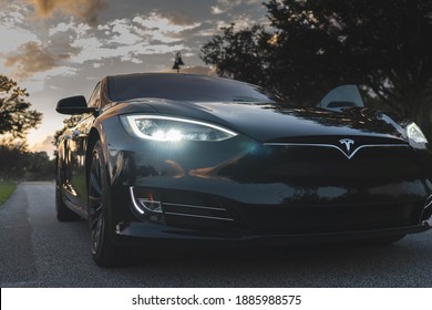 Tampa, FL - October 11, 2020: Tesla Model S Long Range front bumper shot with the sun setting in background