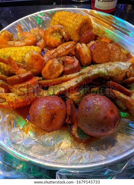 Tampa, FL / USA - February 26, 2020: Mr\
& Mrs Crab Seafood Restaurant - Seafood Boil Combo with\
seasoned shrimp, sausage, potatoes, corn on the cob, Alaskan snow\
crab seasoned to\
perfection.