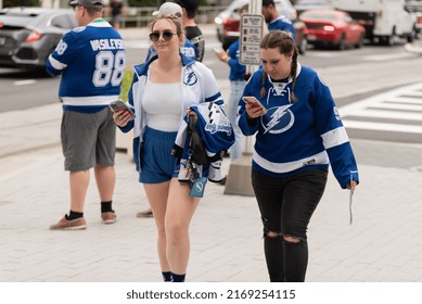 Tampa, FL - USA - June 18, 2022: Tampa Bay Lighting Fans Walking And Looking At Smartphone Outside Amalie Arena Before Game 2 Against The Colorado Avalanche