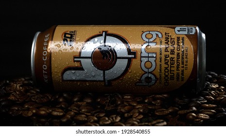 Tampa, FL USA - March 3, 2021: Chocolate Peanut Butter Blast Flavored Bang Protein Keto Energy Drink Laying In Coffee Grounds, Black Background