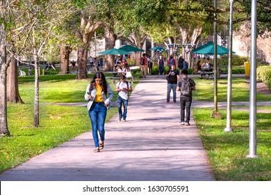 TAMPA, FLORIDA - JANUARY 15, 2020:  Students Walk To Classes And Read Their Phones On The University Of South Florida College Campus Quad