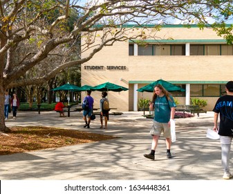 TAMPA, FLORIDA - JANUARY 15, 2020:  Students Walk By The Student Services Building At The University Of South Florida College Campus Quad