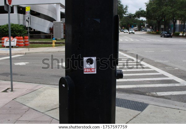 TAMPA, FLORIDA - JUNE 12, 2020: A black lives\
matter sticker posted on a street light pole in the afternoon in\
Tampa, Florida on June 12,\
2020.