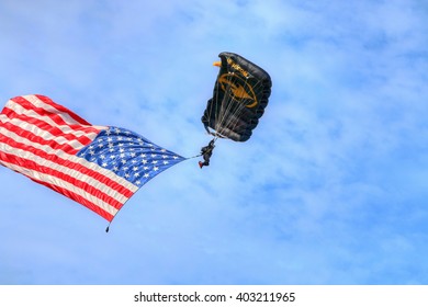 TAMPA, FLORIDA - MARCH 20, 2016: The U.S. Special Operations Command (US SOCOM) Parachute Team Putting On A Demonstration Using A Large American Flag During AirFest 2016. This Was Edited In HDR.