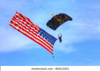 TAMPA, FLORIDA - MARCH 20, 2016: The U.S. Special Operations Command (US SOCOM) Parachute Team Putting On A Demonstration Using A Large American Flag During AirFest 2016. This Was Edited In HDR.