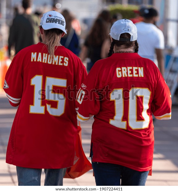 Tampa, Florida  USA\
- January 31, 2021: Two Kansas City Chiefs Fans Wearing American\
Football Jerseys,  Walking to the Super Bowl LV Experience in\
Downtown Tampa Florida.