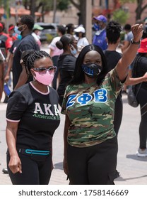 Tampa, Florida / USA - June 14, 2020: Two African American Women, One With Her Fist Raised At National Pan Hellenic Council Black Lives Matter Peaceful Protest In Tampa, Florida. 