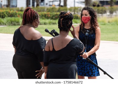 Tampa, Florida / USA - June 14, 2020: Reporter Wearing A Red Mask, Interviewing Two Black Women At The National Pan Hellenic Council Black Lives Matter Peaceful Protest In Tampa, Florida.