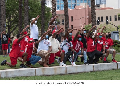 Tampa, Florida / USA - June 14, 2020: Kappa Alpha Psi Fraternity On One Knee With Fist Raised At National Pan Hellenic Council (NPHC) At The Black Lives Matter Peaceful Protest In Tampa, Florida.