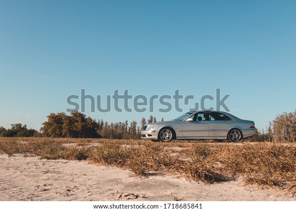 Tampa, Florida | USA | March 19, 2018 - Silver\
Mercedes driving in the\
Fall