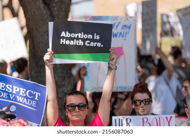 Tampa, Florida - USA - May 14, 2022: Woman Holding a "Aborton is Health Care." Sign at the ‘Bans Off Our Bodies’ Protests Defending Abortion Rights