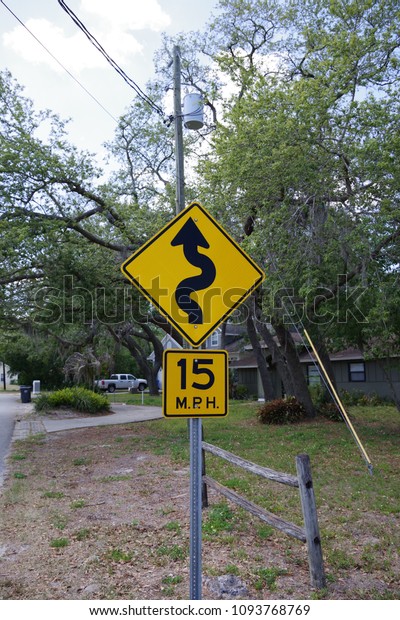 Tampa, Florida / USA - May 5
2018:  15 MPH low angle street sign with the symbol of a squiggly
line 