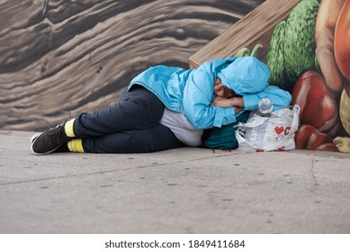 Tampa, Florida / USA - November 7, 2020: Homeless Woman Sleeping on the Streets with Her Belongings in Downtown Tampa Florida