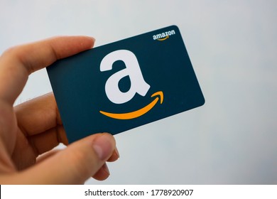 Tampa, FL/USA July 7, 2020: Someone hand is holding an amazon gift card. Amazon is one of the largest company for eCommerce 