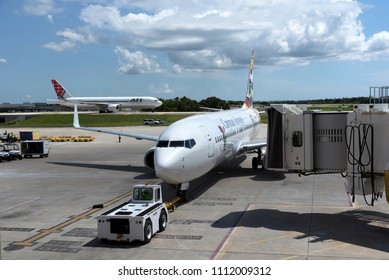 Tampa International Airport Florida USA. 2018. A Cayman Airways Passenger Jet Being Pushed Back From The Stand.