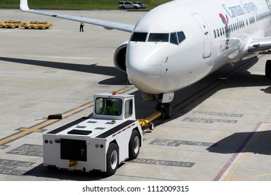 Tampa International Airport Florida USA. 2018. A Cayman Airways Passenger Jet Being Pushed Back From The Stand.