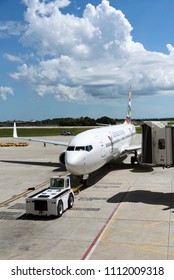 Tampa International Airport Florida USA. 2018. A Cayman Airways Passenger Jet Being Pushed Back From The Stand.