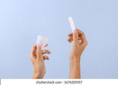 Tampon Or Menstrual Cup. Woman Hands On Pastel Blue Background. Zero Waste Alternatives, Hygiene Period Product.