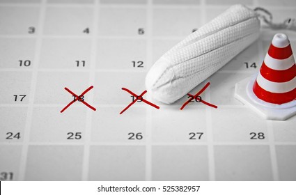 tampon on calendar with traffic cone toy, abstract background to period and healthy concept.