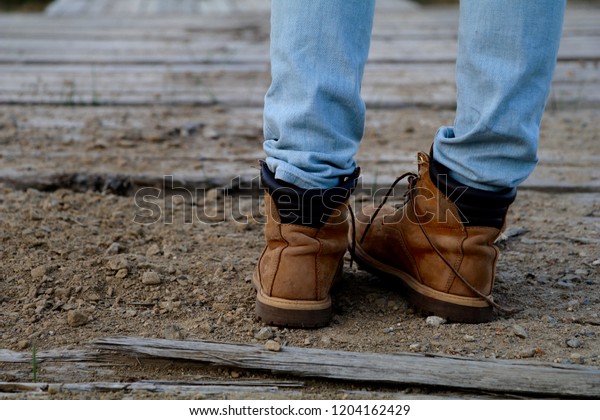 tan boots blue jeans