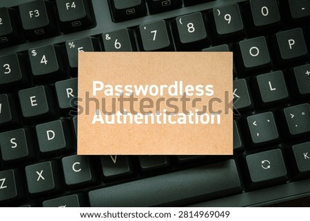 Tan card displaying 'Passwordless Authentication' text resting on a dark keyboard, symbolizing modern digital security and identity verification. Perfect eyecatcher for IT security and business technology articles.